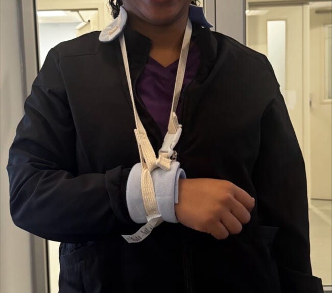Improvised collar and cuff sling made from a Posey soft limb holder, worn with the elbow at 90 degrees and the wrist supported